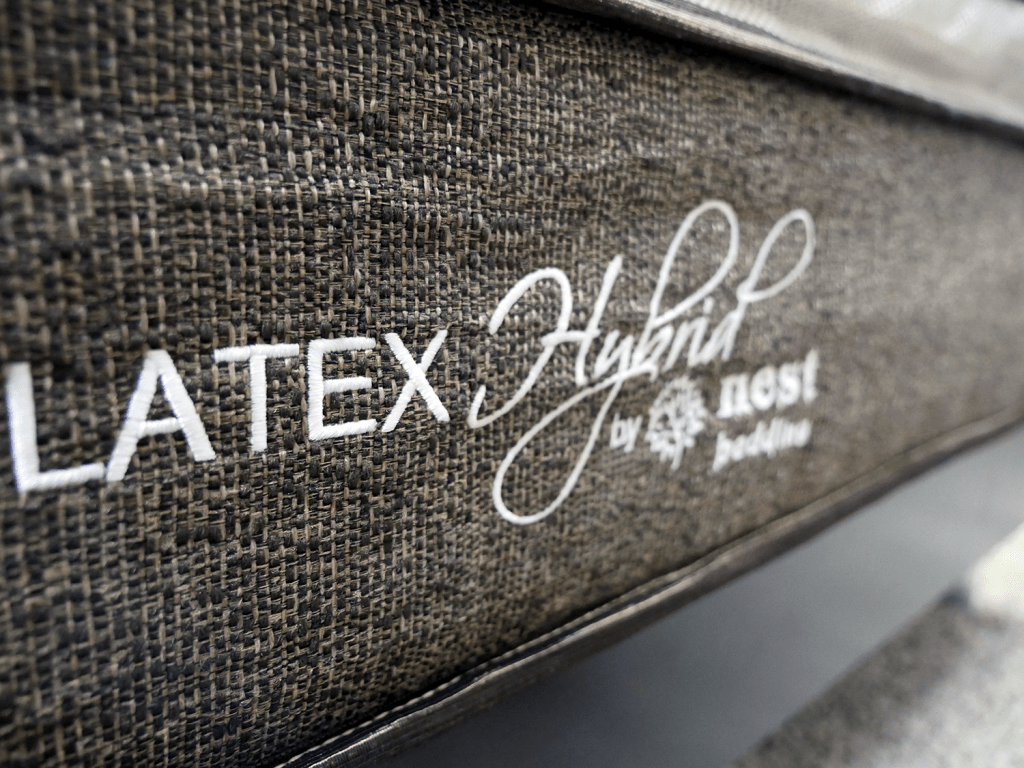 Close up shot of the Nest latex hybrid mattress logo