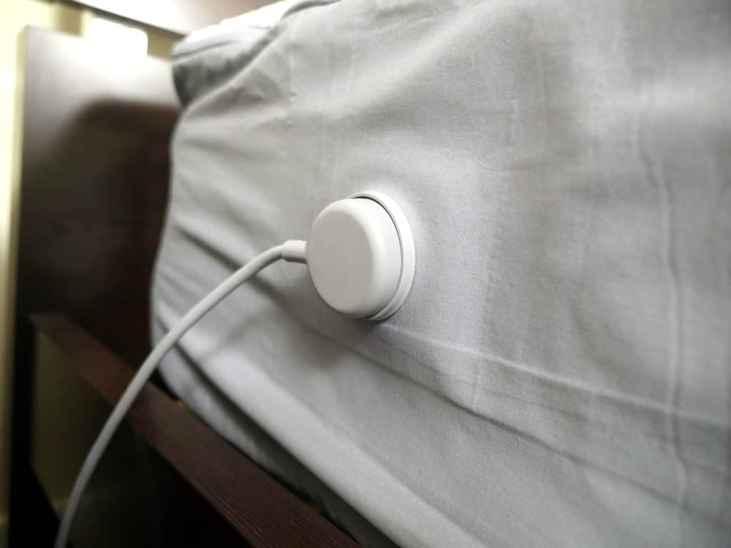Close up shot of the Eight Sleep sheet connected to the power source of the sleep tracking system