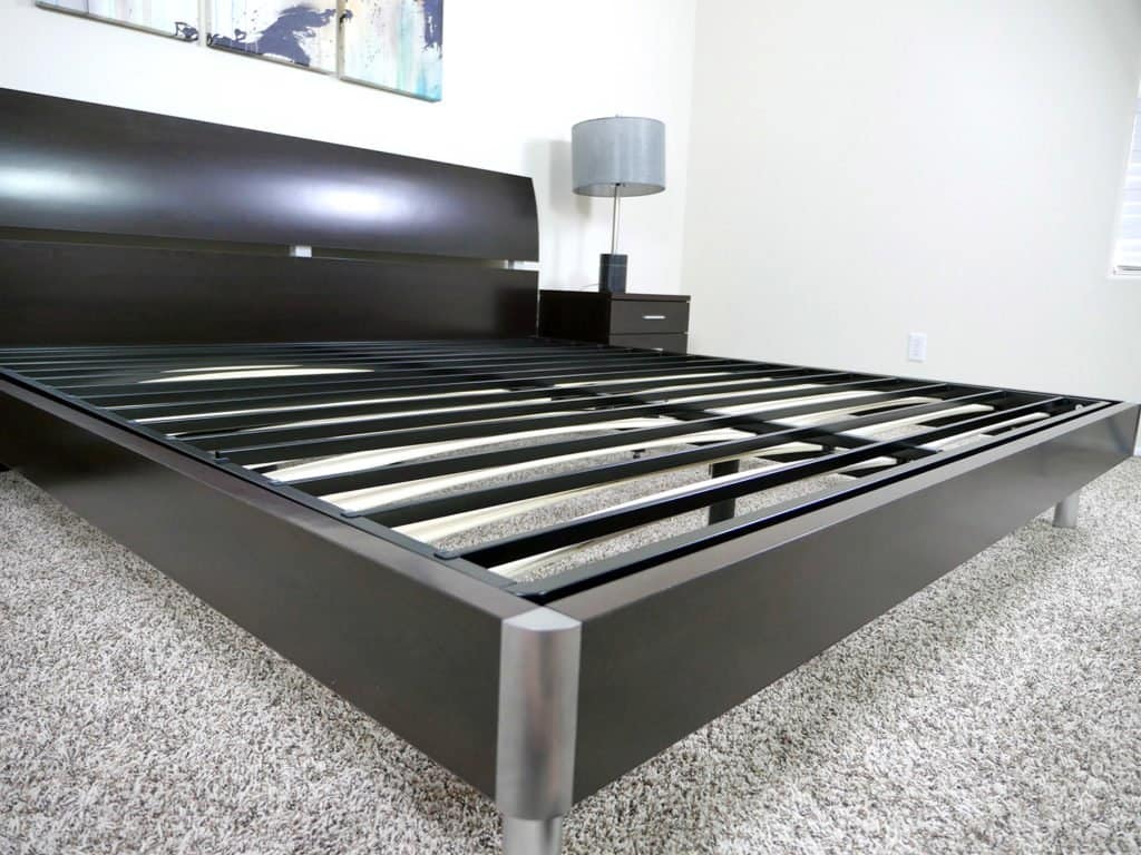 Angled view of the Zinus Bunkie Board sitting on top of an existing platform bed