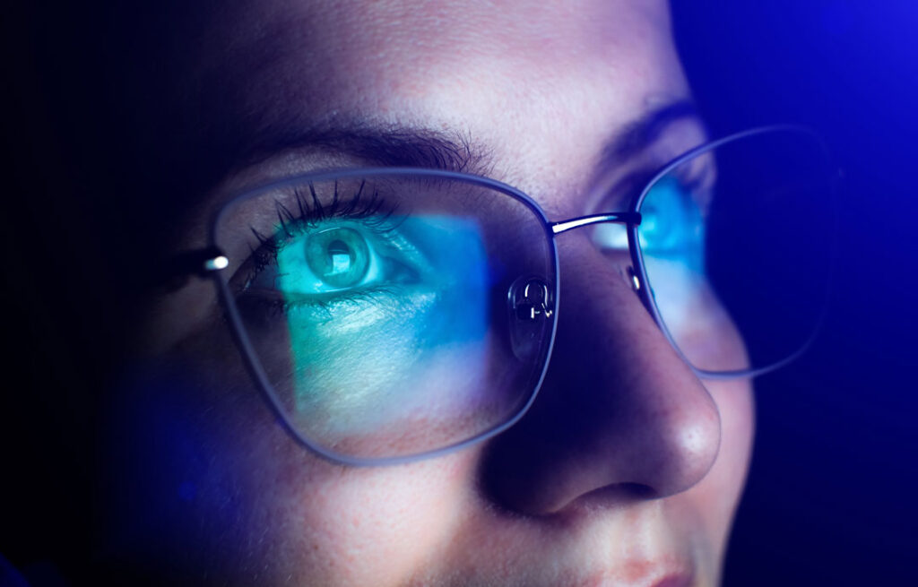 woman wearing blue light blocking glasses