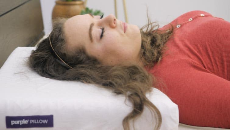 Head resting on Purple Pillow