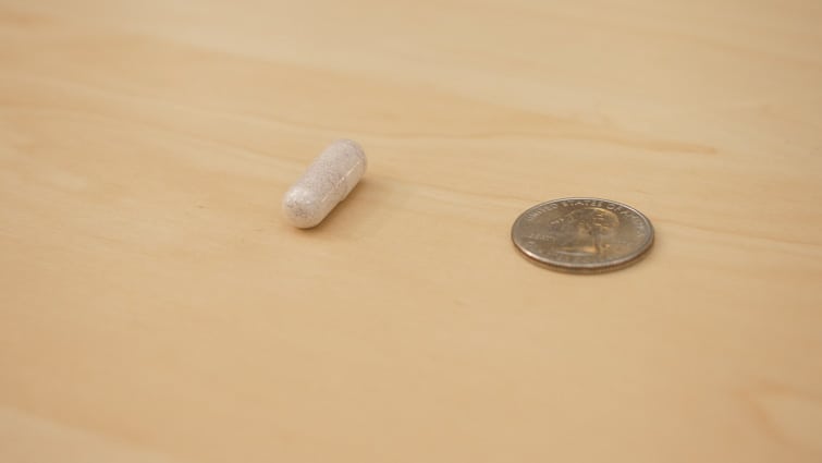 Performance Lab Sleep pill size compared to a quarter