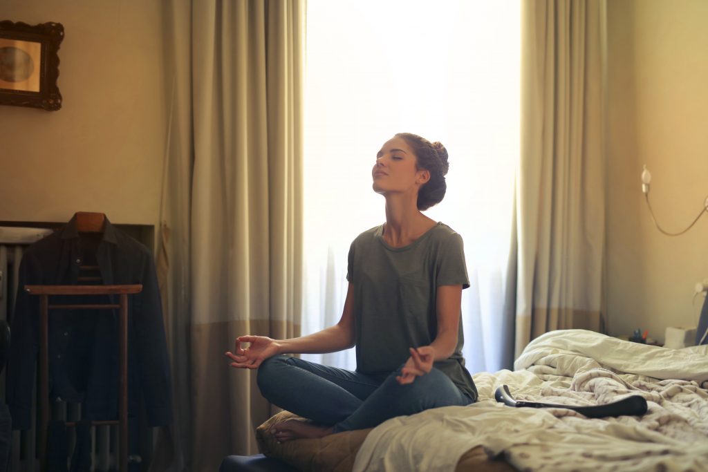 woman meditating in bedroom 3772612 1