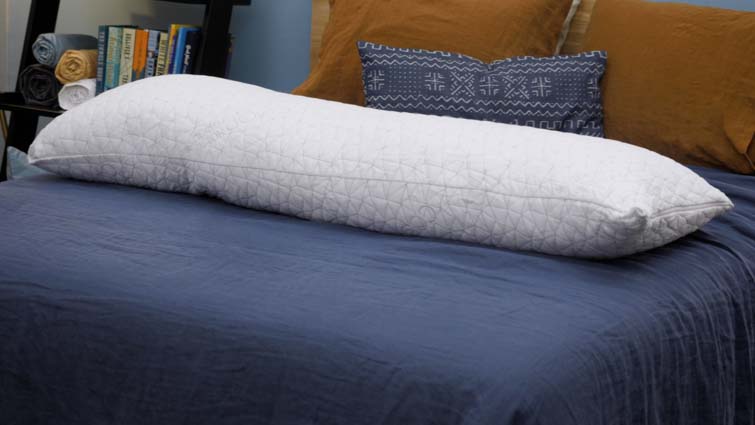 The Coop Home Goods body pillow on a bed