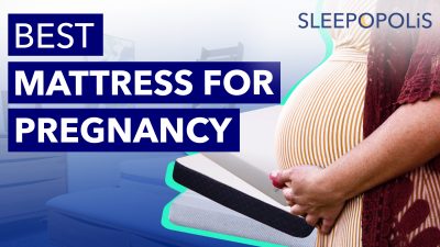pregnant woman in front of mattresses