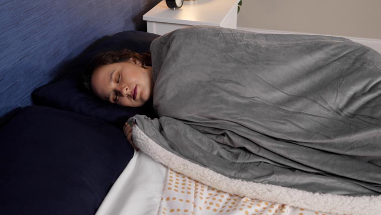 woman underneath the weighted blanket