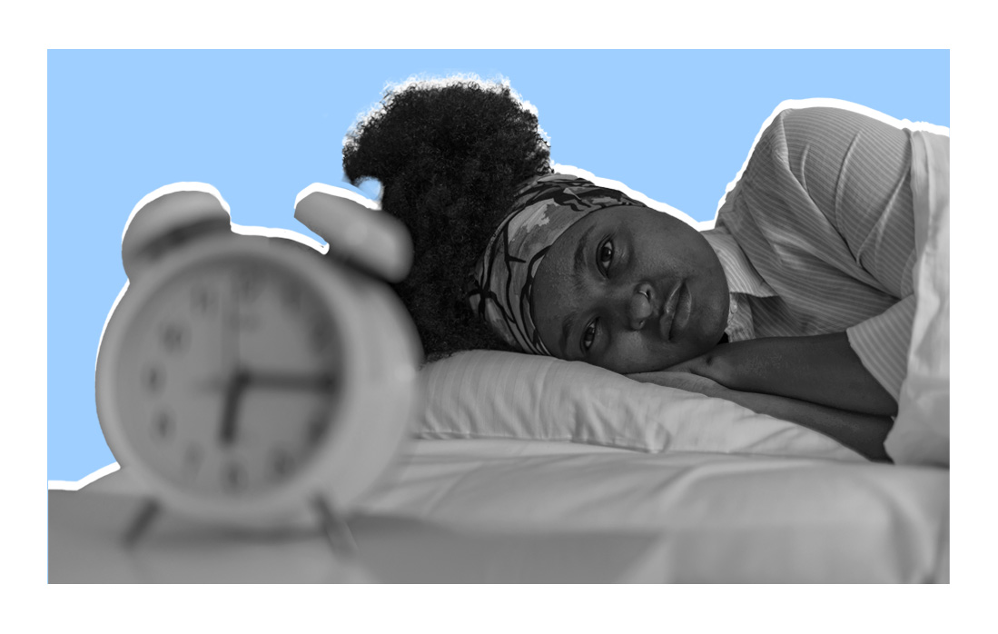 Woman looking at alarm clock