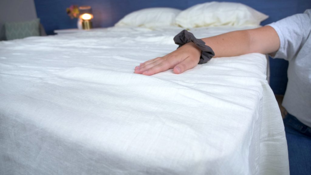 hand on the saatva linen sheets