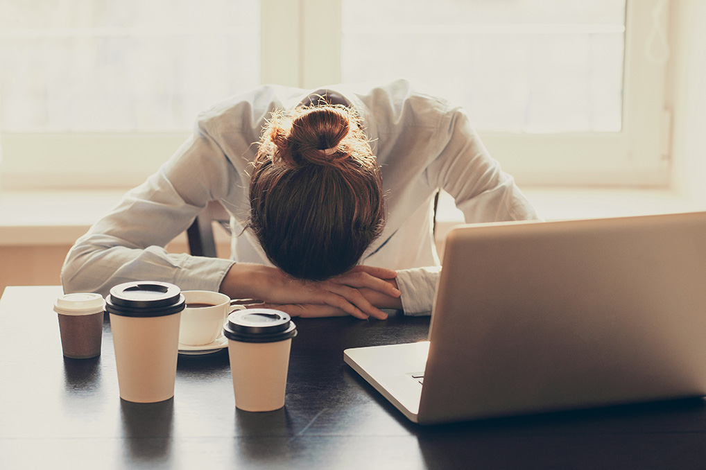 Sleep Deprivation woman asleep at desk