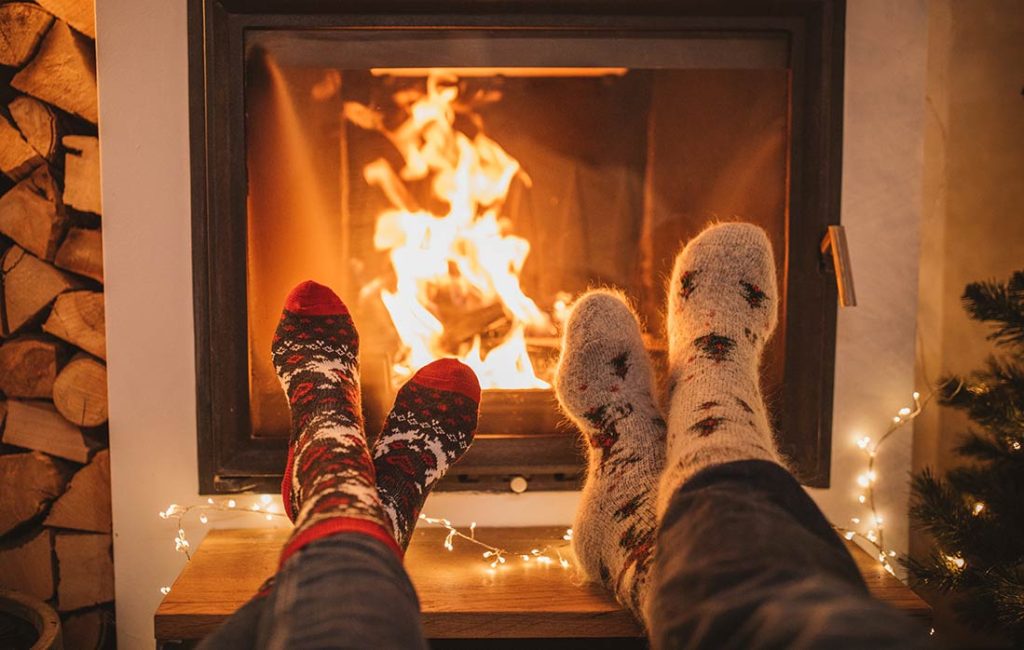 Close-up shot of two people in front of a fire