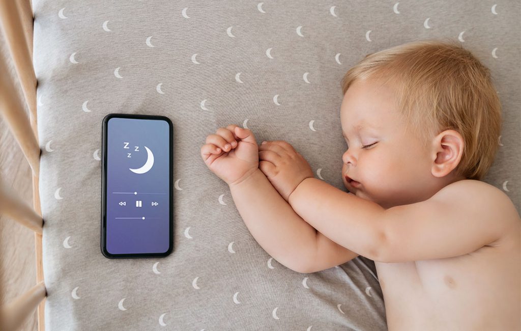 newborn sleeping listening to music