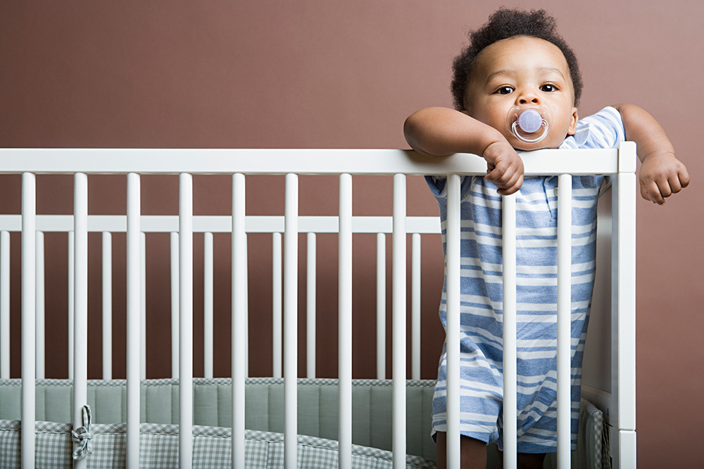 Baby standing up in his crib