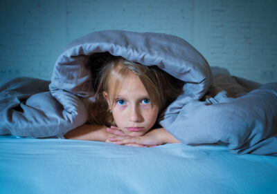 older child awake in bed