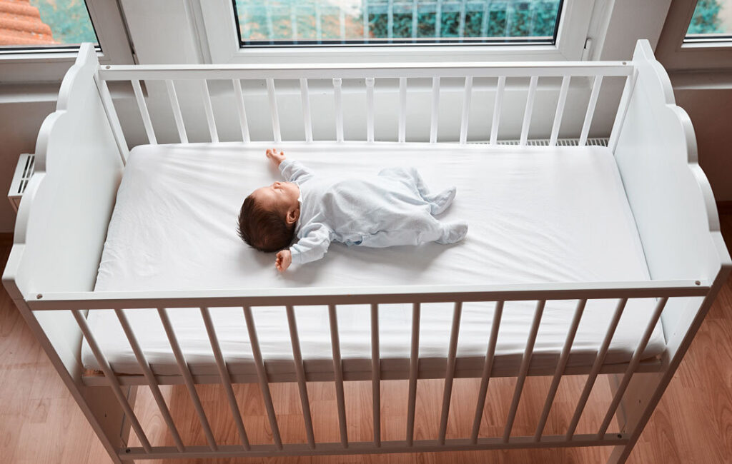 baby sleeping on crib mattress