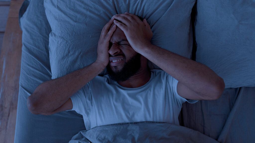 man suffering from night headaches