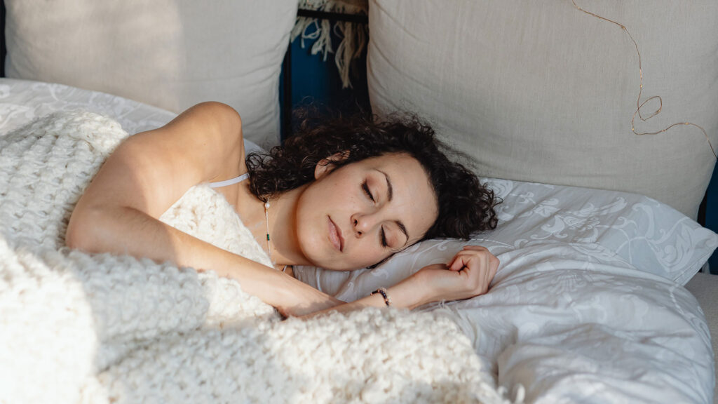 How to Sleep on Your Back, According to Sleep Experts