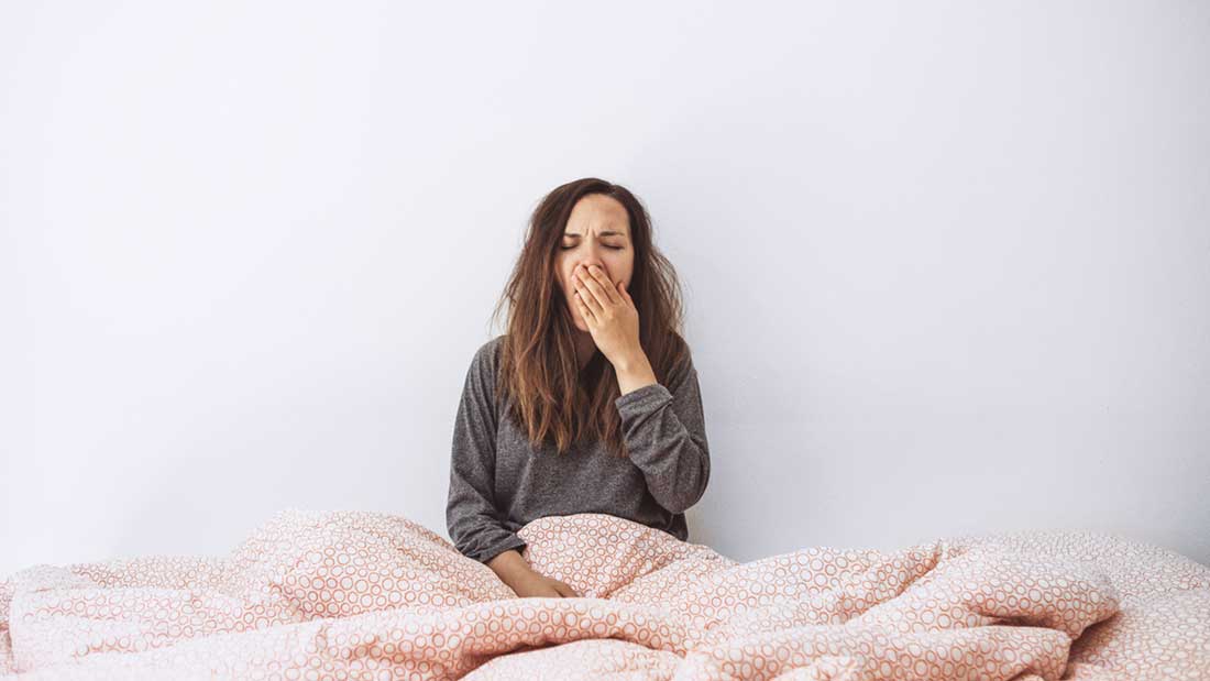 woman yawning in bed