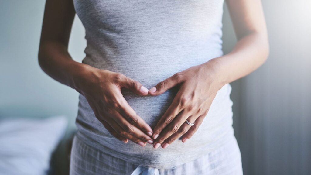 pregnant woman touching her belly