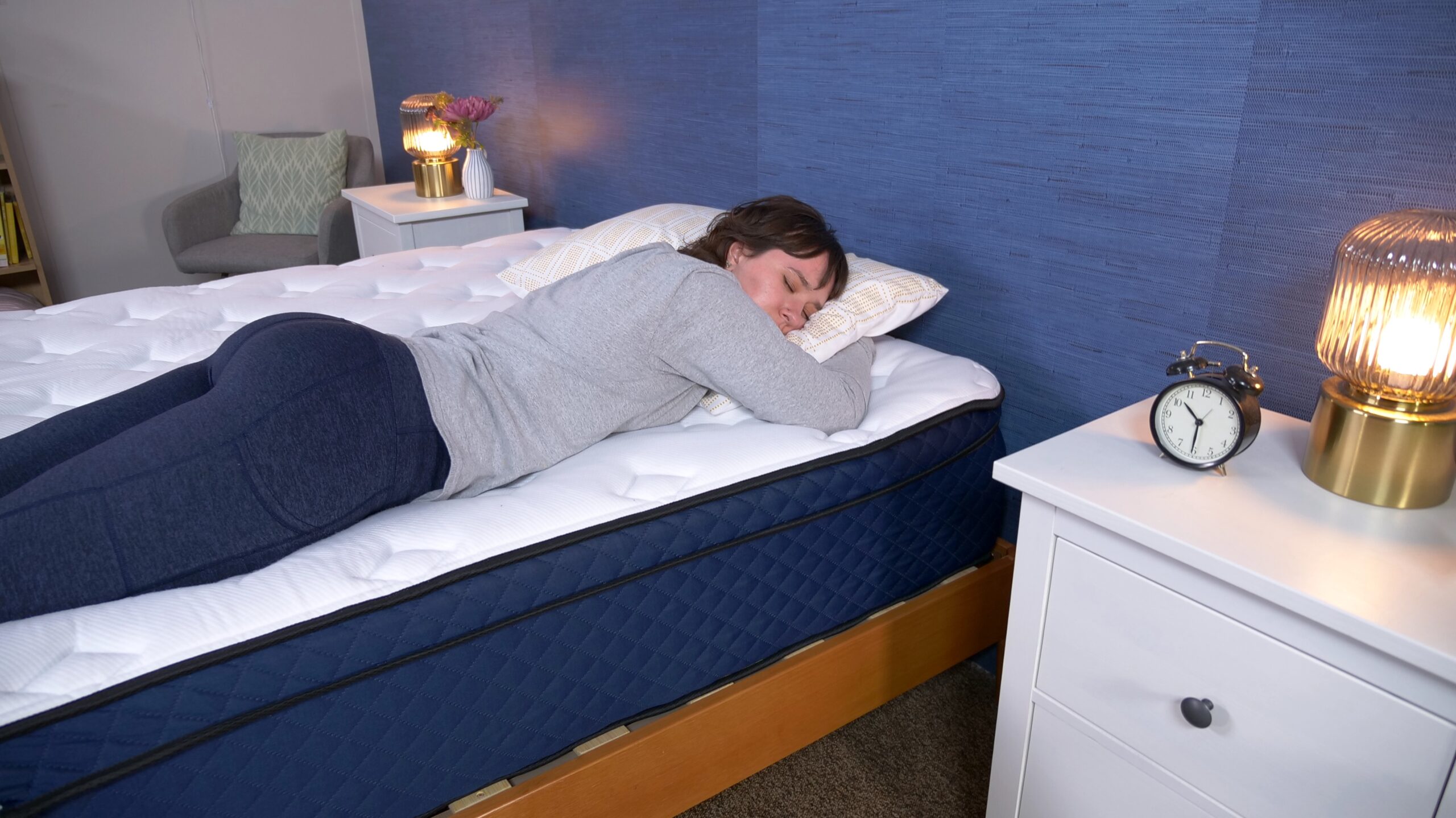 Woman lying on stomach on mattress