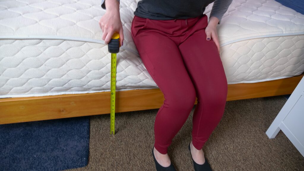 Nichole doing the yardstick test on the WinkBeds EcoCloud Hybrid Mattress