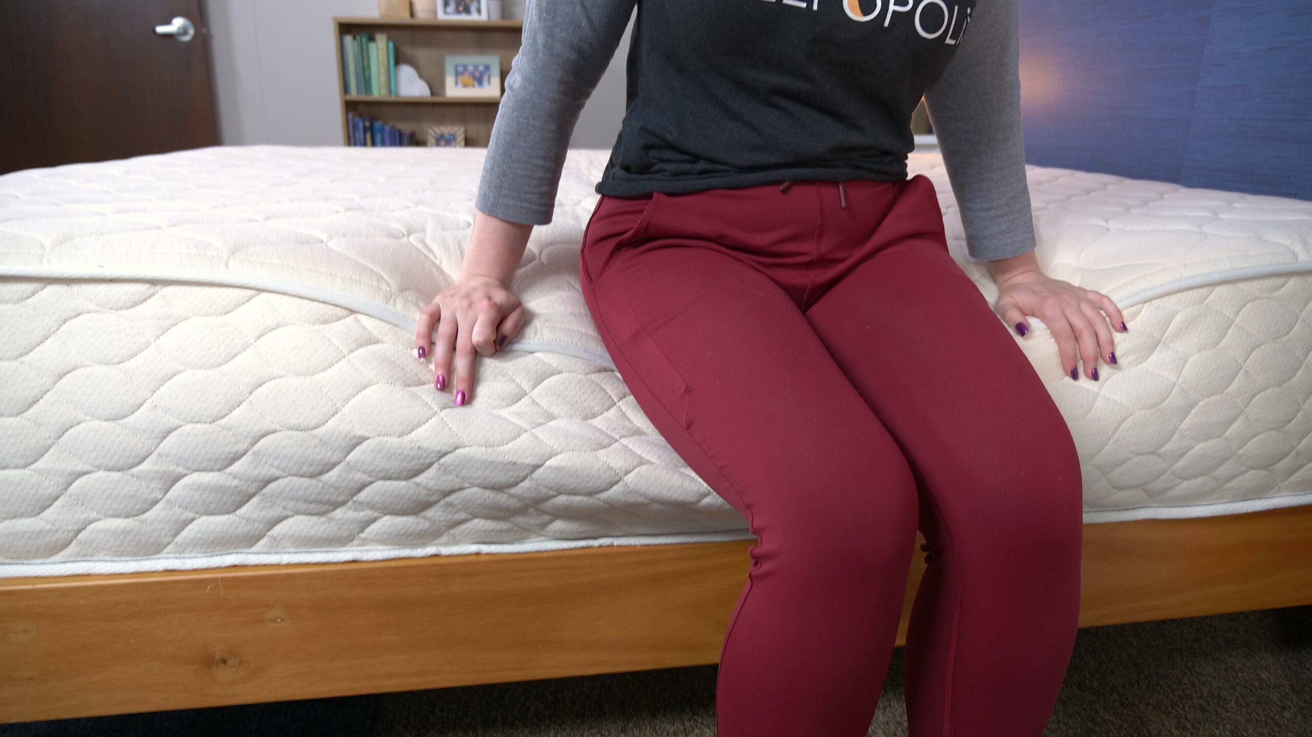 Nichole testing the edge support on the WinkBeds EcoCloud Hybrid Mattress