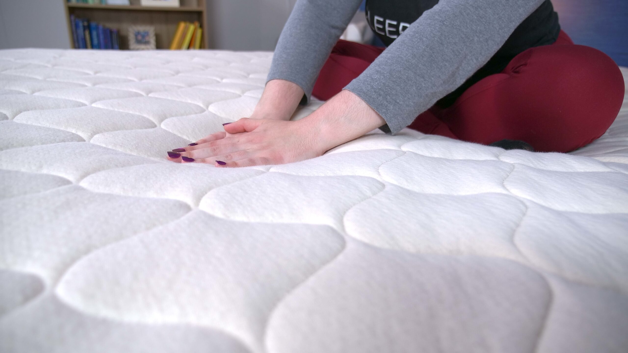 Nichole feeling the cover on the WinkBeds EcoCloud Hybrid Mattress