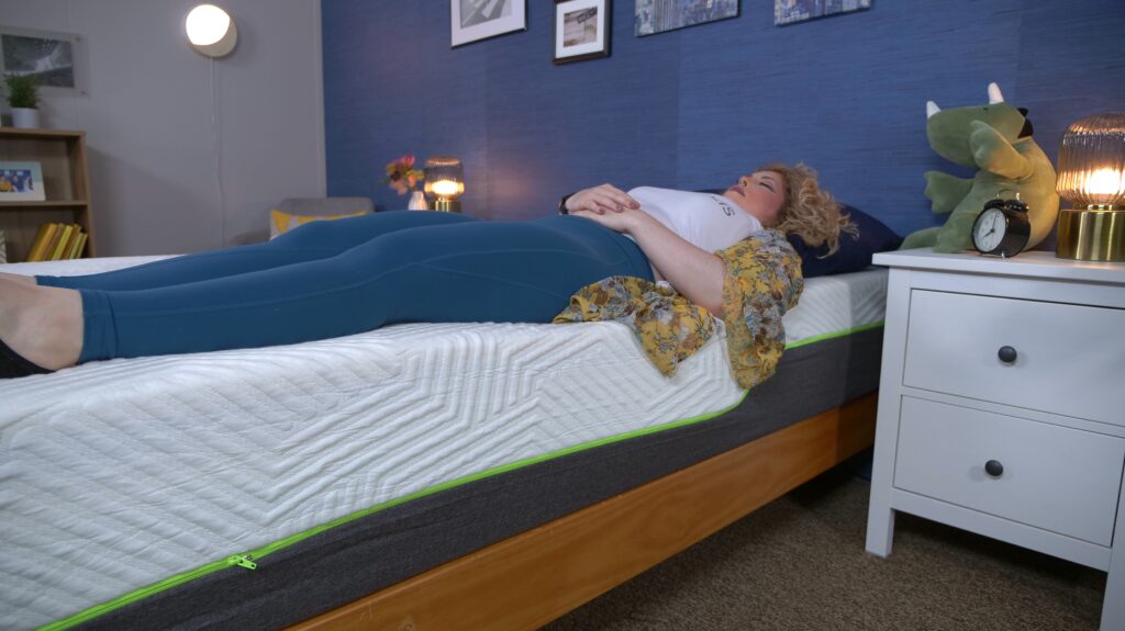 Nichole testing the edge support of the Lucid Hybrid mattress.