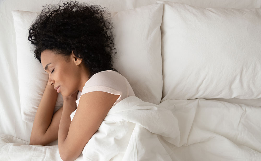 Woman Sleeping on Several Pillows