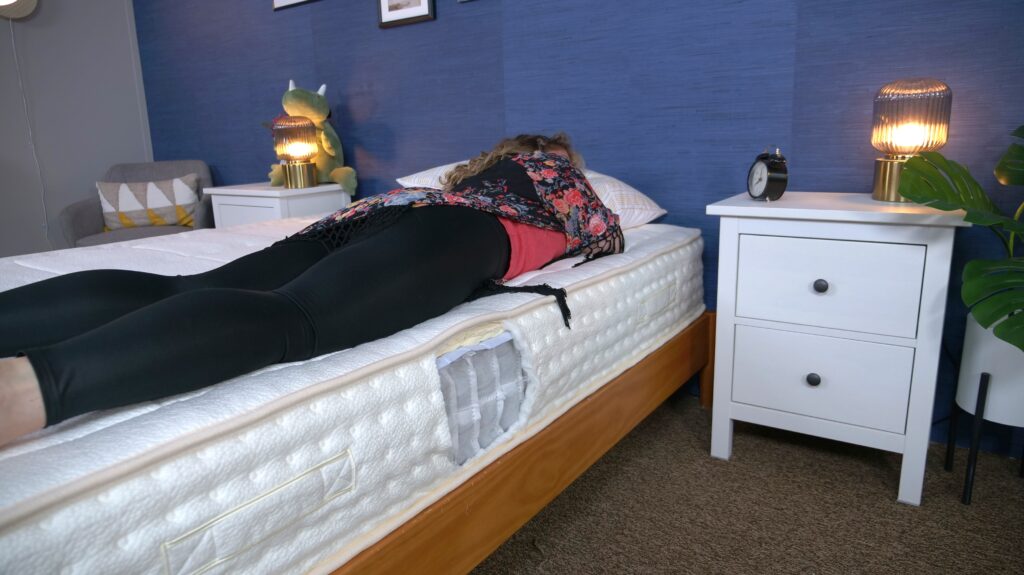 Nichole stomach sleeping on the Awara Natural Luxury Hybrid mattress.