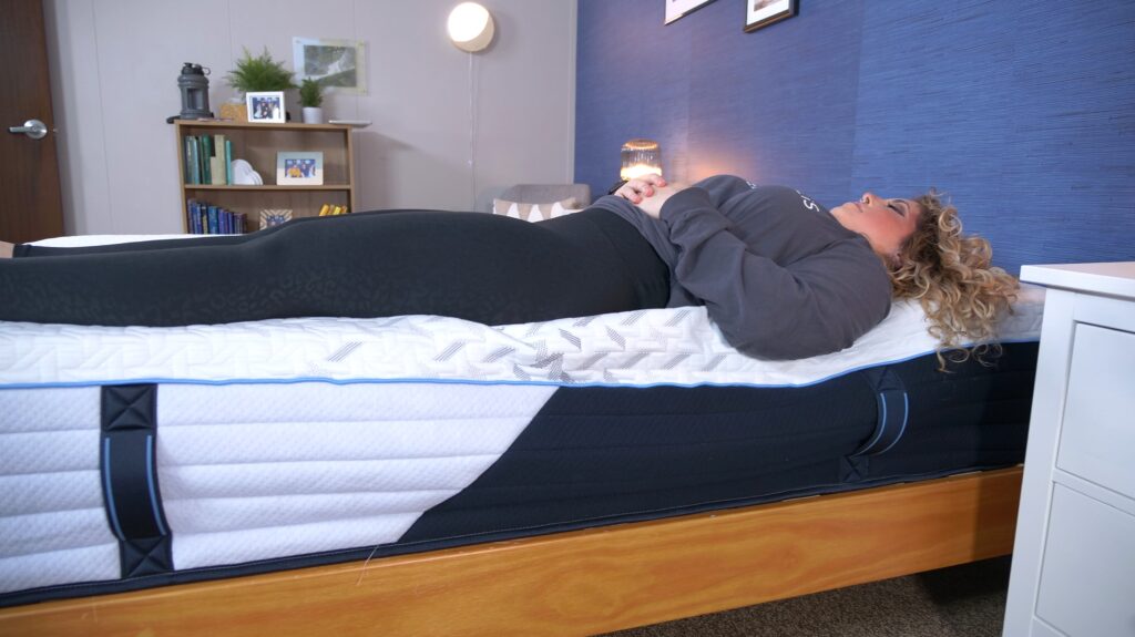 Nichole testing the edge support on the Nectar Classic Hybrid mattress.