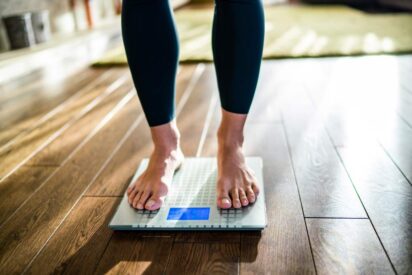 woman stepping on a scale