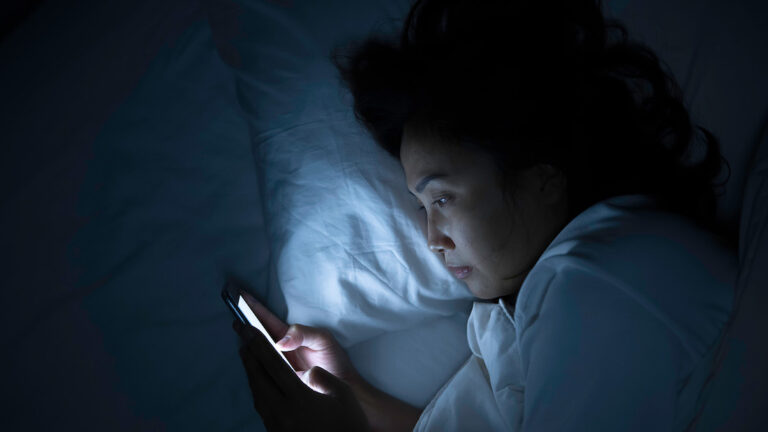 woman enjoying screen time before bed