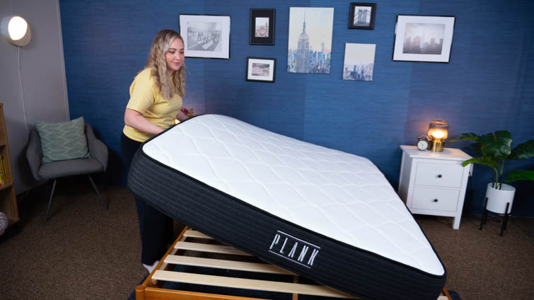 Mattress tester Bridget flipping the Plank mattress onto its extra-firm side.