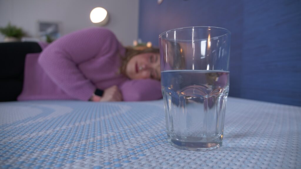 Nichole performing the water test on the TEMPUR-ProBreeze mattress.