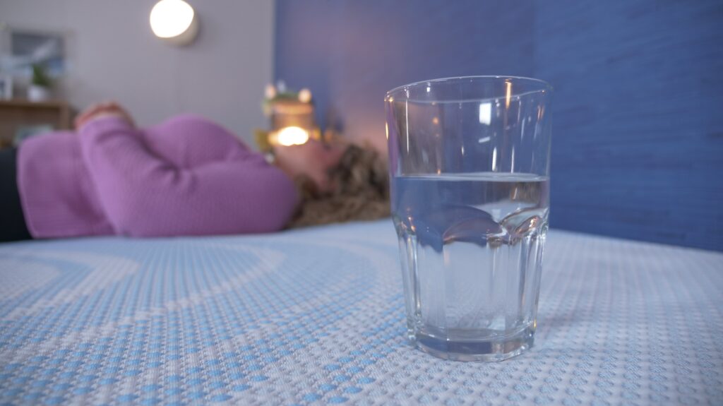 Nichole performing the water test on the TEMPUR-ProBreeze mattress.