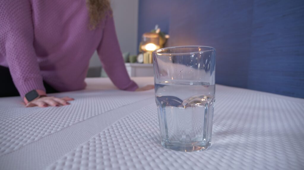 Nichole performing the water test on the TEMPUR-Cloud mattress.