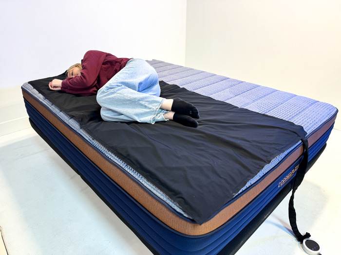A woman lying on the Brooklyn Bedding CopperFlex mattress in the side-sleeping position.