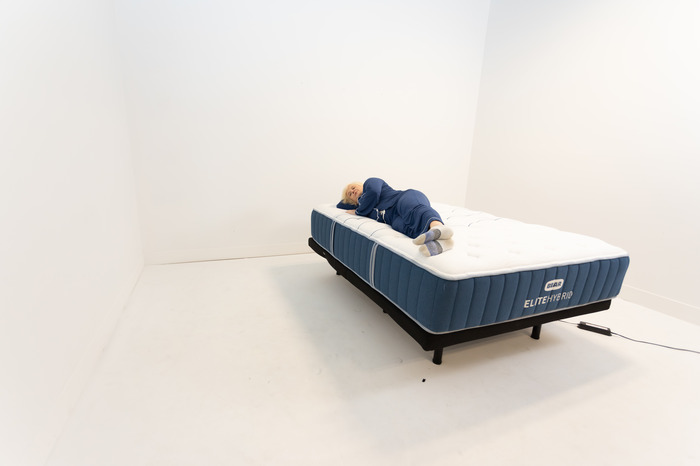 A person side sleeping on a Bear Elite Hybrid mattress.