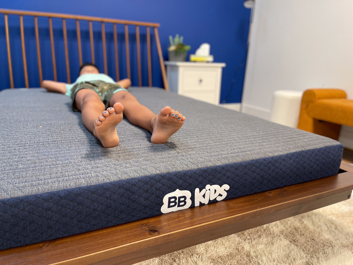 A 10-year-old boy testing out the BB Kids mattress in the back-sleeping position.