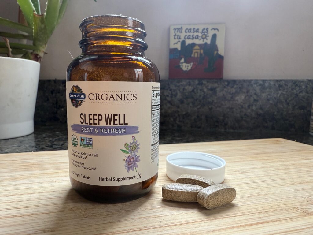 Garden of Life Sleep Well capsules next to the opened bottle.
