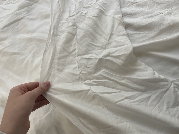 Riley Otis peels back a Sijo Airy Weight Tencel Sheet.