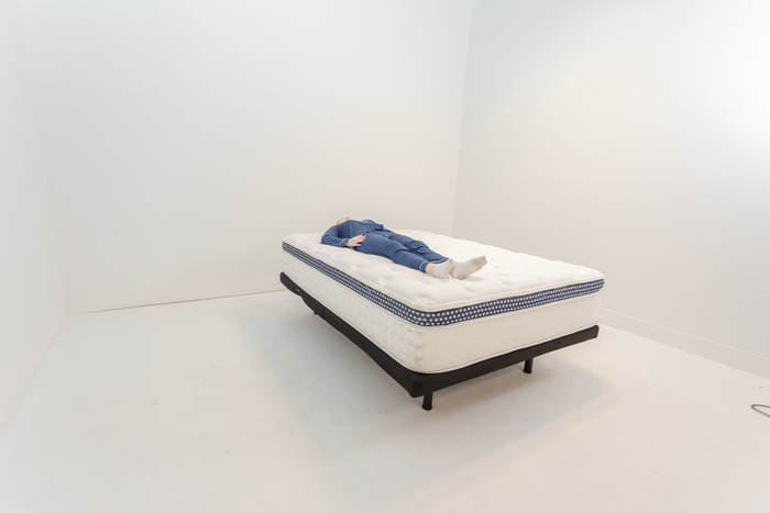 A woman lying on the WinkBed on her back.