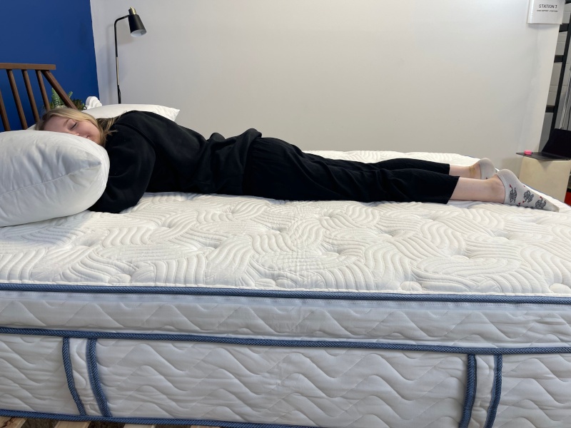 Our tester stomach-sleeping on the DLX Premier Hybrid