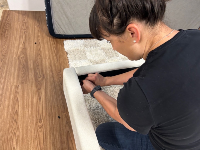 Kate Meier screws together the structural elements of a DreamCloud Claremont Bed Frame.