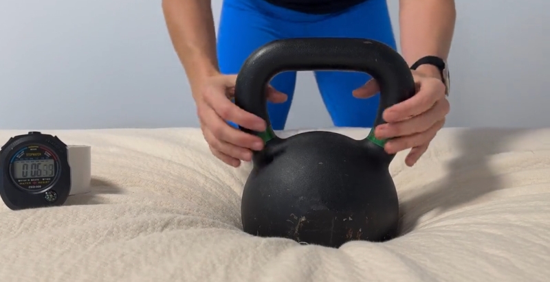 Our tester performs a responsiveness test on the Avocado Eco Organic Mattress