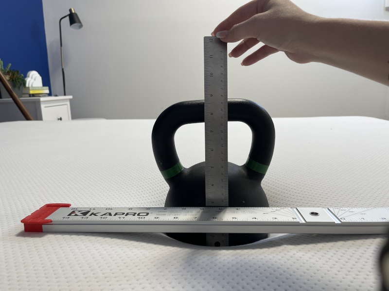 Our tester performs a sinkage test on a Boring AF Mattress