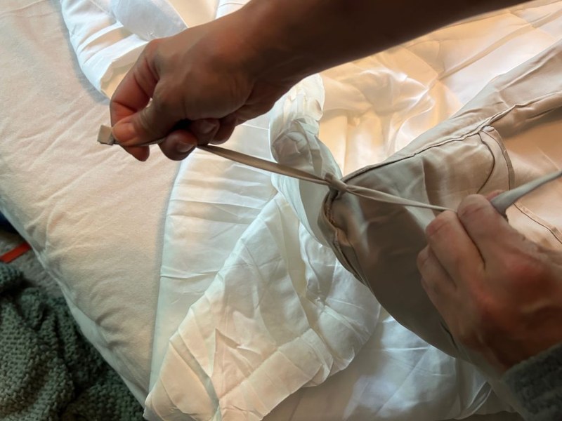 Our tester attaching a Buffy Breeze Comforter to a duvet cover