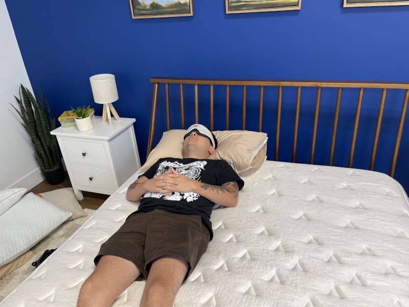 Our tester back-sleeping on a Glacier Summit Hybrid Mattress