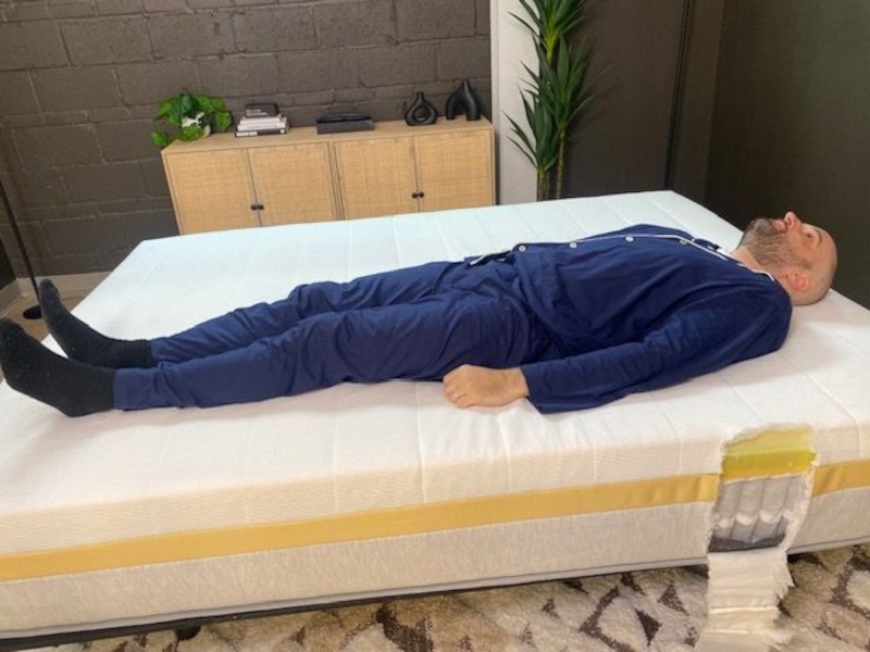 Our tester back-sleeping on a Helix Dawn Mattress