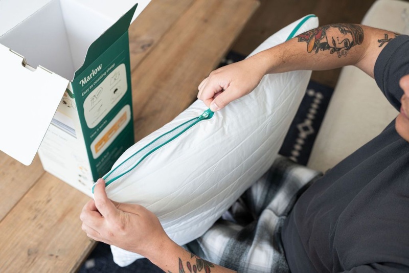 Our tester unzips the Brooklinen Marlow Pillow